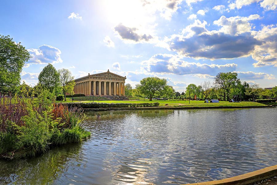 Contact Us - Nashville Parthenon in Centennial Park, Lake Watauga in the Foreground, Trees Along the Banks